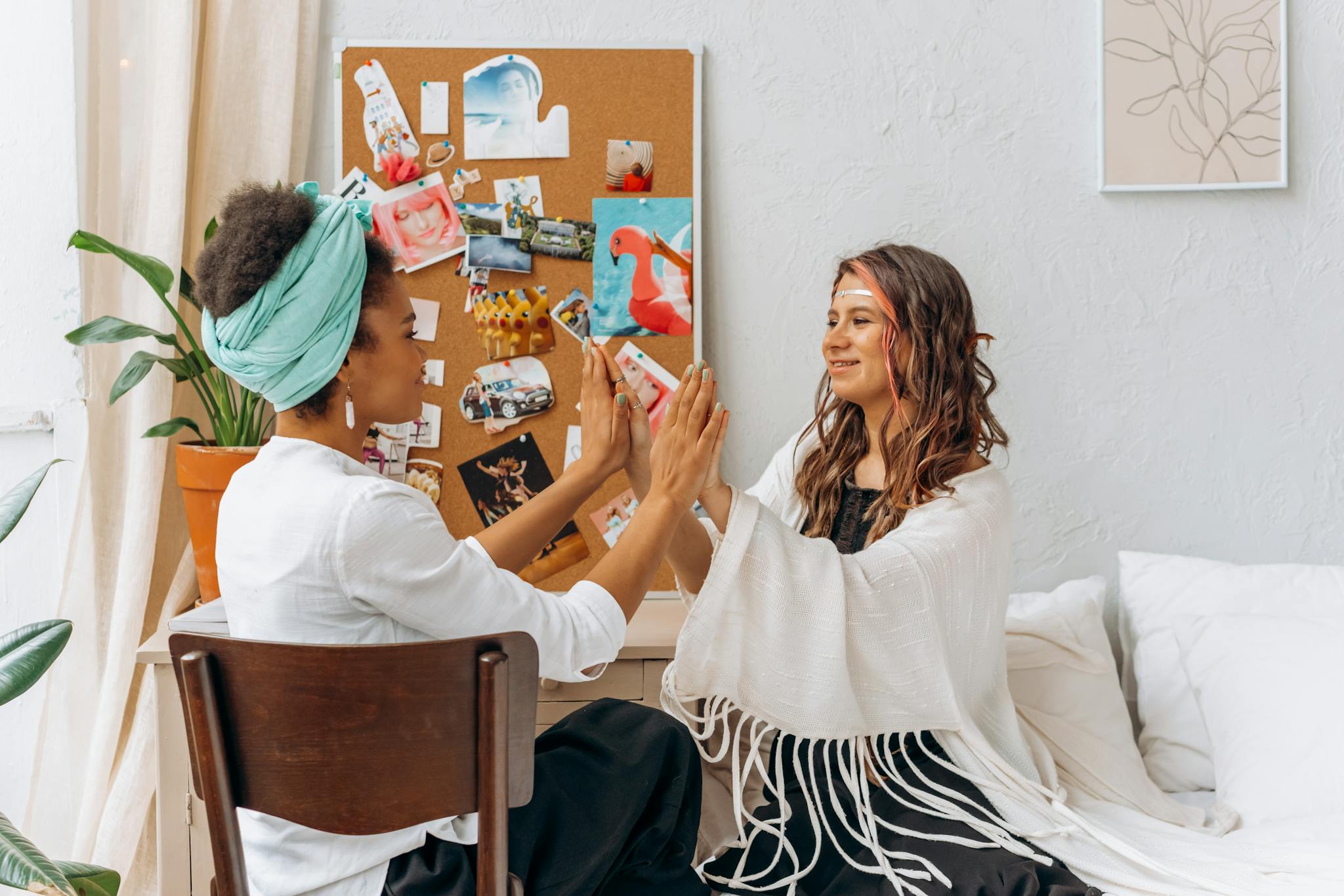 Two women practicing a spiritual ritual at home, fostering connection and relaxation.